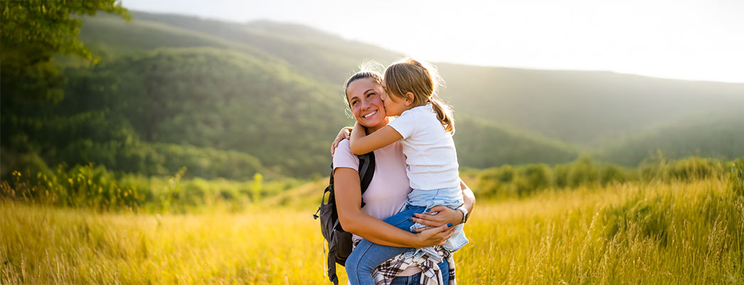 Mutter hält ihre 10-jährige auf dem Tochter auf dem Arm