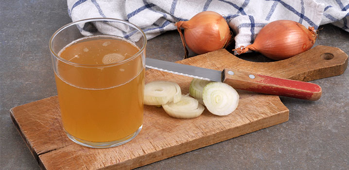 Schneidebrett mit Zwiebeln und Zwiebelsirup