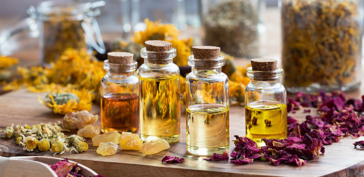 Kleine Glasfläschchen mit Korken zwischen Blütenblättern